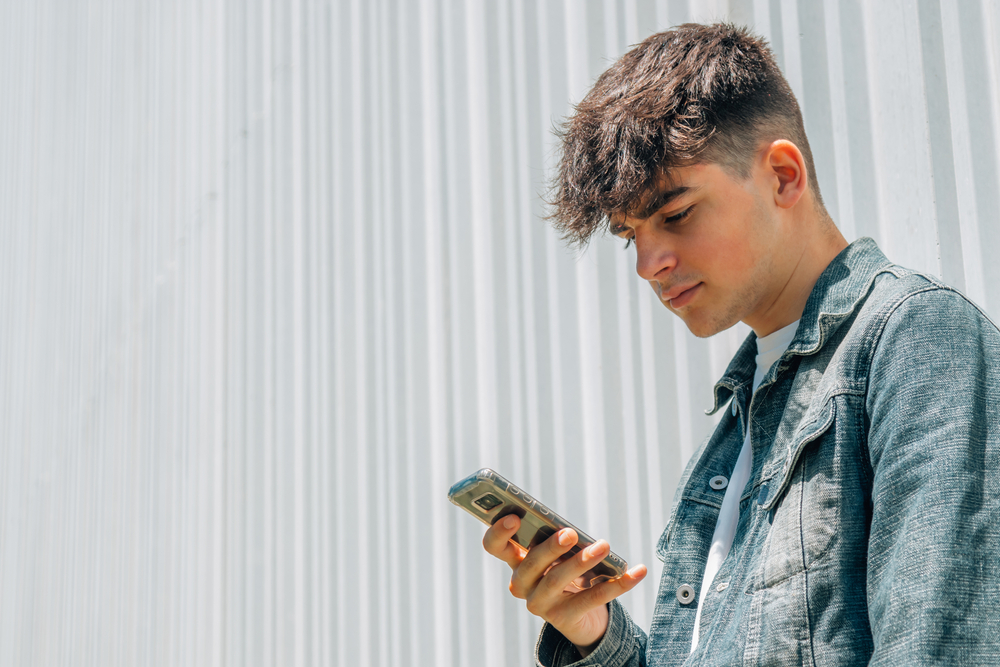 Teenage boy looking at mobile phone