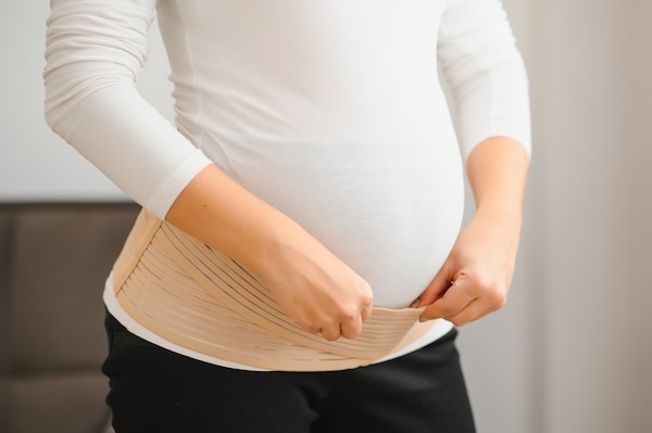 Woman puts on Belly Band